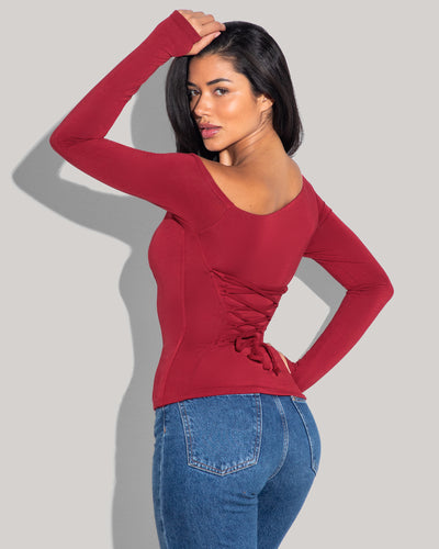 Model is posing in Shapey Long Sleeve One Shoulder Sculpting Shapewear Top - Ruby back view