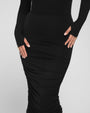 Model wears Shapey Off Shoulder Ruched Midi Shapewear Dress - Black close up of the bottom of the dress