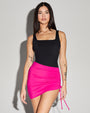 Model wears Skirty Waterproof & Sunproof Shapewear Mini Cover-Up - Pink and square black one piece swimsuit