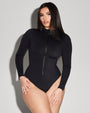 Model wears Surfy - Black One Piece Long Sleeve Shapewear Swimsuit full front view with closed zipper