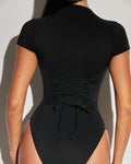 Model wears Short Sleeve Surfy One Piece Sculpting Shapewear Swimsuit - Black back view