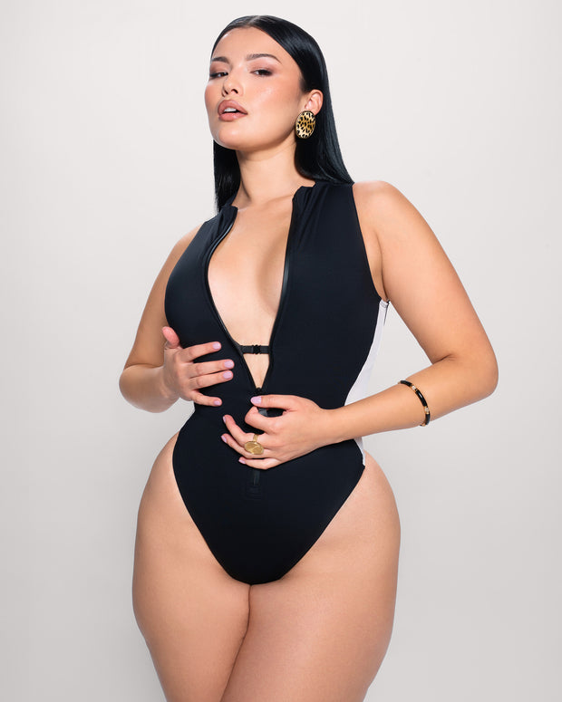 Model posing in Hi Cut Sleeveless Surfy - Contour Black/White showing bust support detail