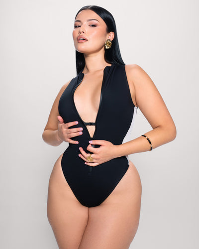 Model posing in Hi Cut Sleeveless Surfy - Contour Black/White showing bust support detail