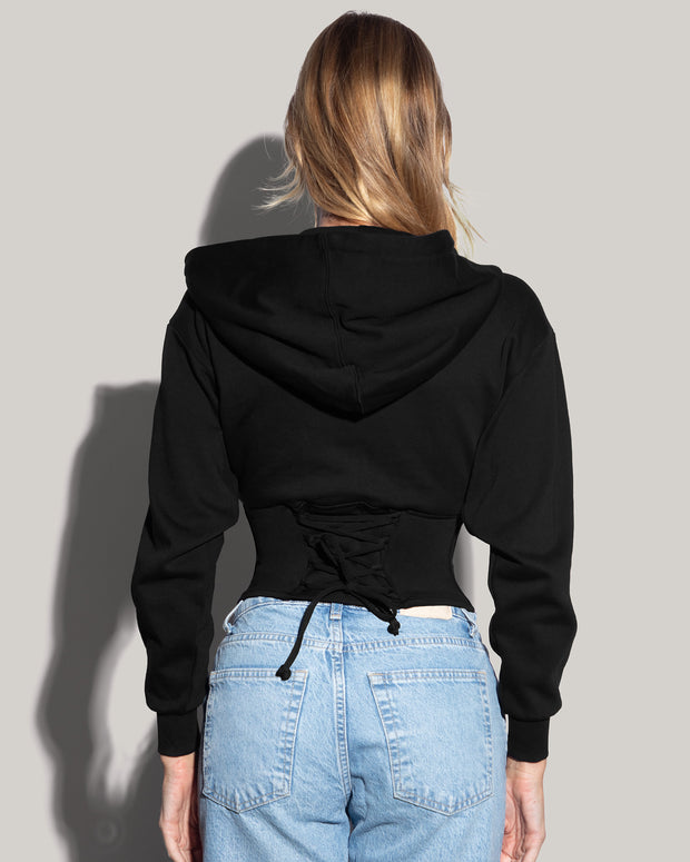 Model is posing in Corsety Long Sleeve Shapewear Hoodie - Black back view