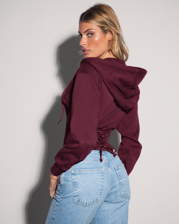 Model is wearing Corsety Long Sleeve Shapewear Hoodie - Dark Cherry side view