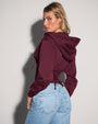 Model is wearing Corsety Long Sleeve Shapewear Hoodie - Dark Cherry side view