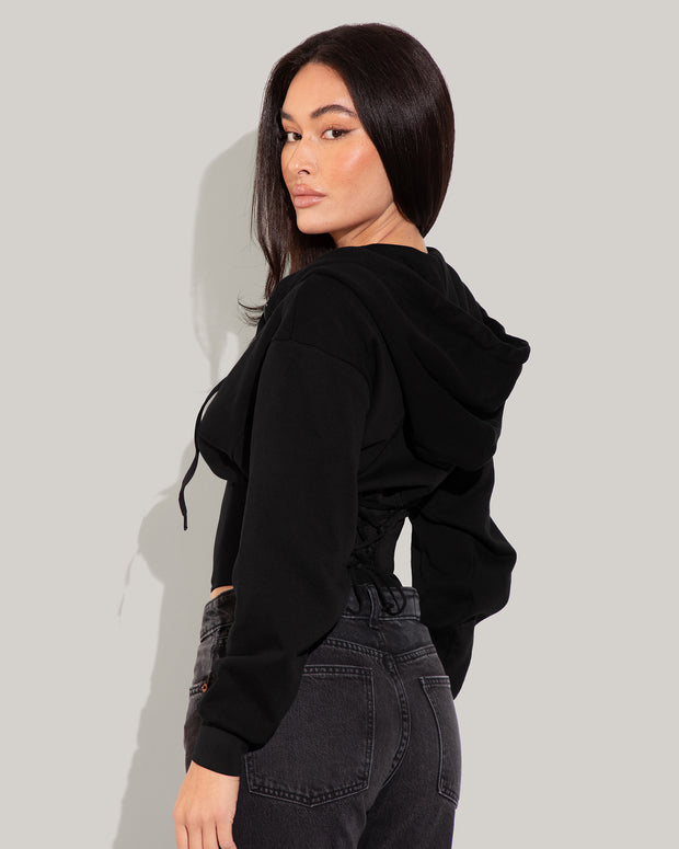 Model is posing in Corsety Long Sleeve Shapewear Hoodie - Black side view