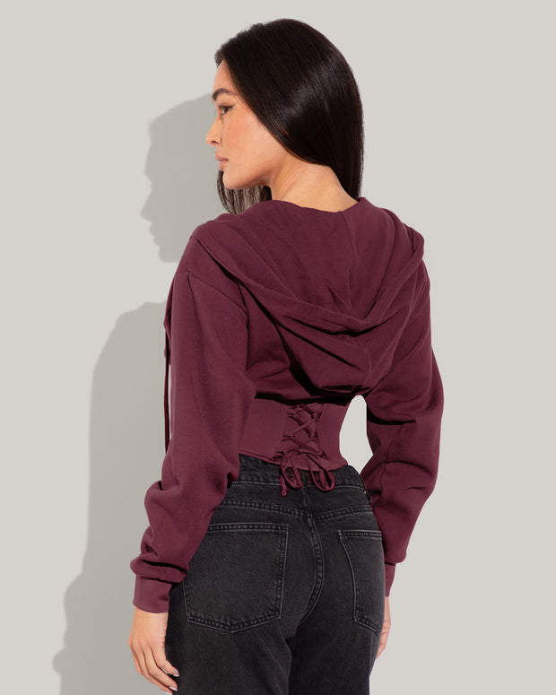 Model is wearing Corsety Long Sleeve Shapewear Hoodie - Dark Cherry back view