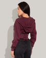 Model is wearing Corsety Long Sleeve Shapewear Hoodie - Dark Cherry back view