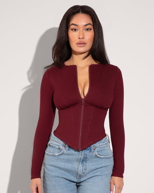 Model is in Long Sleeve Corsety Sculpting Shapewear Top - Dark Cherry front view