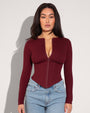 Model is in Long Sleeve Corsety Sculpting Shapewear Top - Dark Cherry front view