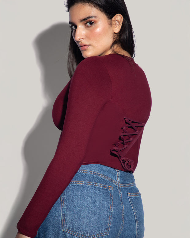 Model is in Long Sleeve Corsety Sculpting Shapewear Top - Dark Cherry side view