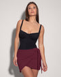 Model wears Mini Wrap Skirty Built-in Shapewear Swim Cover-Up - Dark Cherry