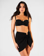 Model wearing Ringy Mini Skirty - Black paired with Bombshell Bikini Top - Black front view