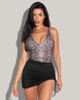 Model is posing in Skirty Waterproof & Sunproof Shapewear Mini Cover-Up - Black and snake ombre one piece