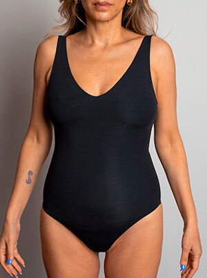 Front view of model in a standard swimsuit before wearing TA3 Lifty shaping swimwear.