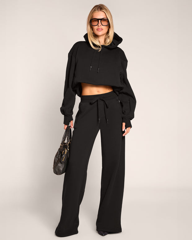Full body of model wearing Model wearing Convertible Fleecey - Black cropped at the shortest length 