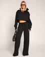 Full body of model wearing Model wearing Convertible Fleecey - Black cropped at the shortest length 