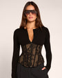 Front view of model wearing Corsety Long Sleeve Top - Lace Black/Tawny half zipped